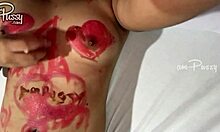 An amateur Asian girl paints her hairless body with lipstick in the nude